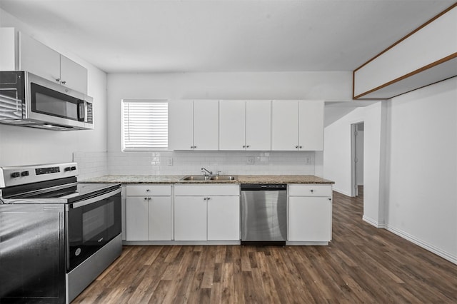 kitchen with appliances with stainless steel finishes, dark hardwood / wood-style floors, and white cabinets