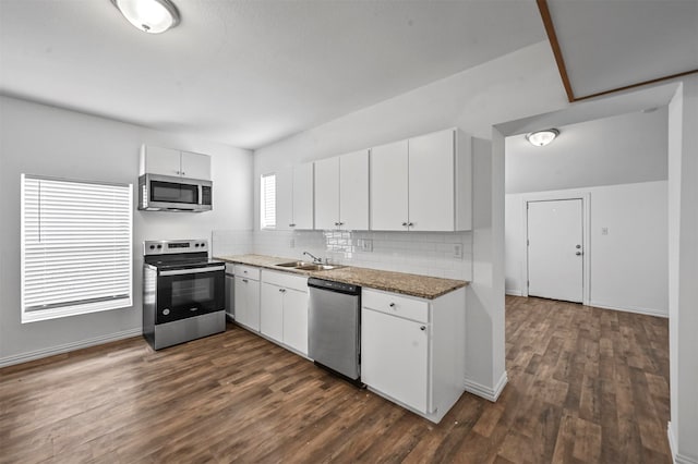 kitchen featuring white cabinetry, a healthy amount of sunlight, appliances with stainless steel finishes, and dark hardwood / wood-style floors