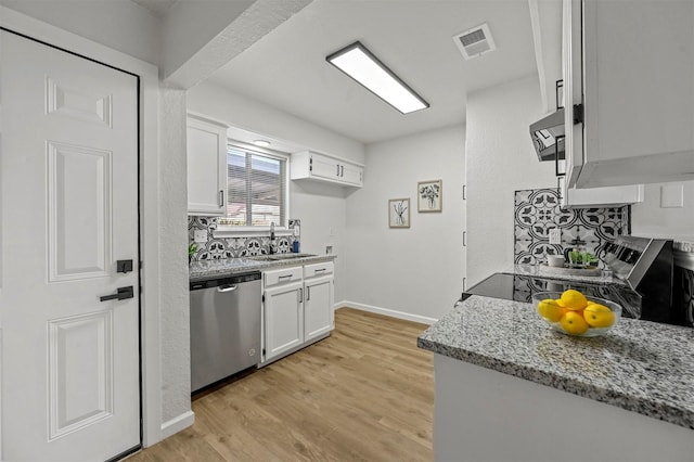 kitchen featuring light stone countertops, stainless steel dishwasher, sink, light hardwood / wood-style flooring, and white cabinets