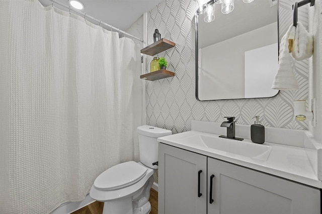 bathroom featuring toilet, vanity, and hardwood / wood-style flooring