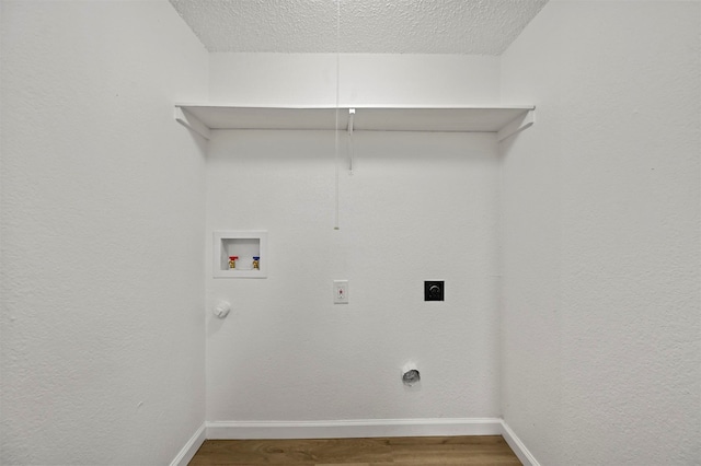 clothes washing area with hardwood / wood-style flooring, electric dryer hookup, a textured ceiling, and hookup for a washing machine