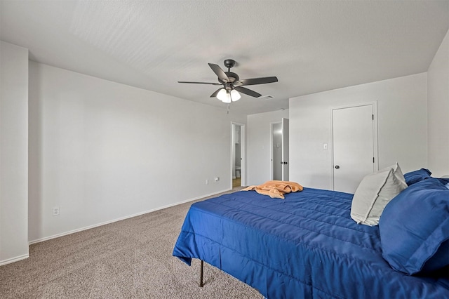 carpeted bedroom with a textured ceiling and ceiling fan