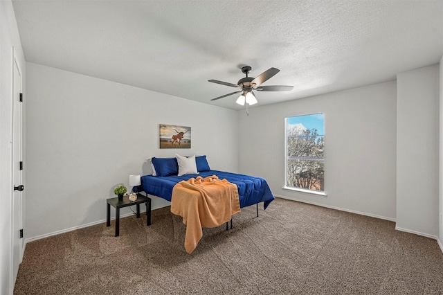 bedroom featuring a textured ceiling, carpet floors, and ceiling fan