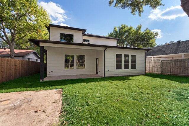 back of house featuring a patio and a lawn