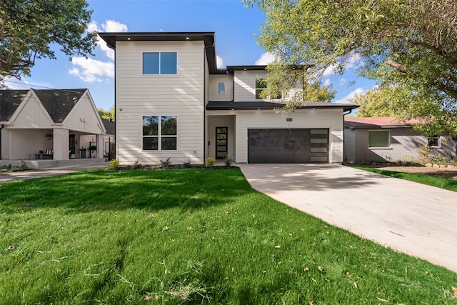 modern home featuring a front yard and a garage