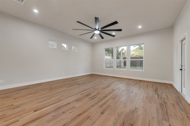 spare room featuring light hardwood / wood-style flooring and ceiling fan