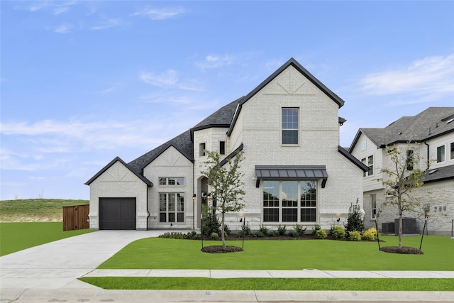 french country inspired facade featuring a front yard and a garage