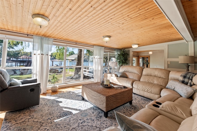 living room with a water view, wooden ceiling, plenty of natural light, and hardwood / wood-style floors