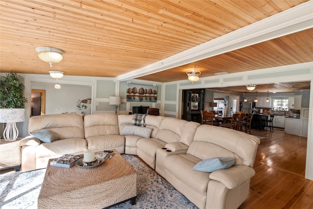 living room featuring crown molding, wooden ceiling, wood-type flooring, and lofted ceiling