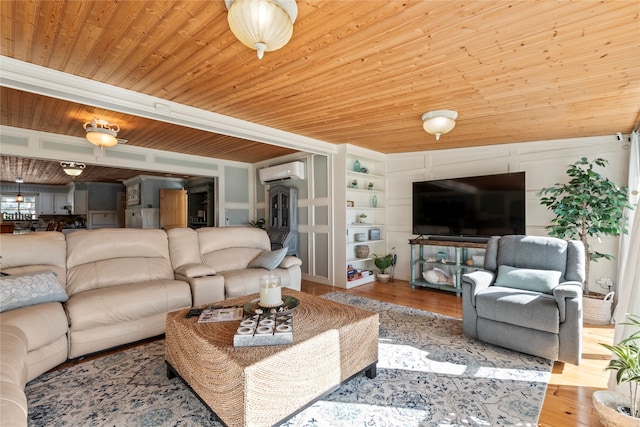 living room featuring a wall unit AC, hardwood / wood-style floors, wooden ceiling, and built in features