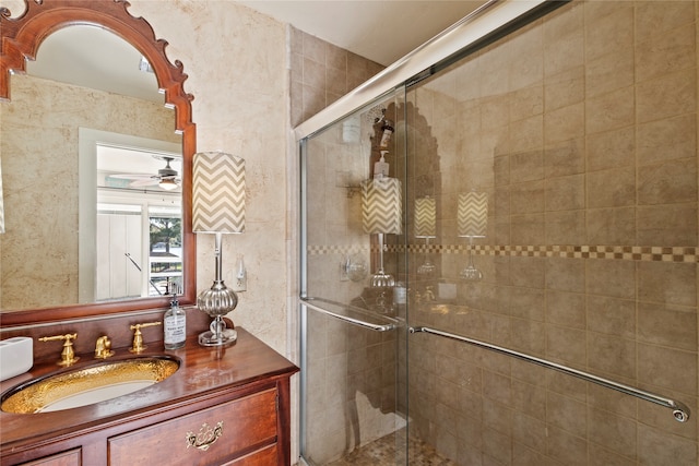 bathroom with vanity, ceiling fan, and a shower with door