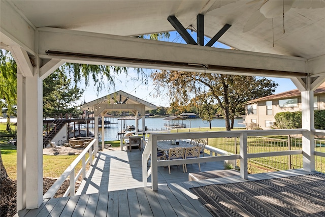 deck featuring a water view, a gazebo, and a yard