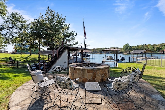 view of patio / terrace featuring an outdoor fire pit and a water view