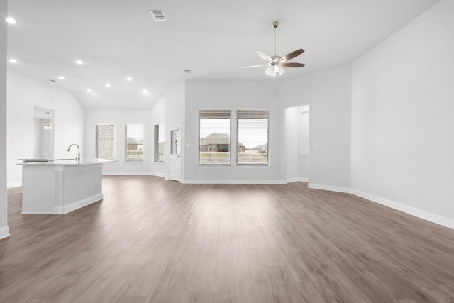 unfurnished living room with recessed lighting, visible vents, baseboards, and wood finished floors