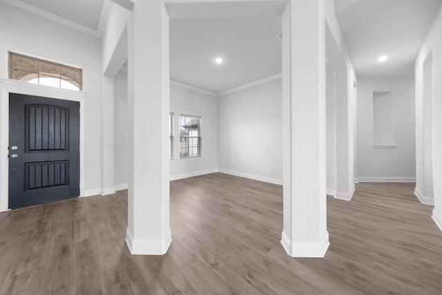 entrance foyer with crown molding and wood finished floors