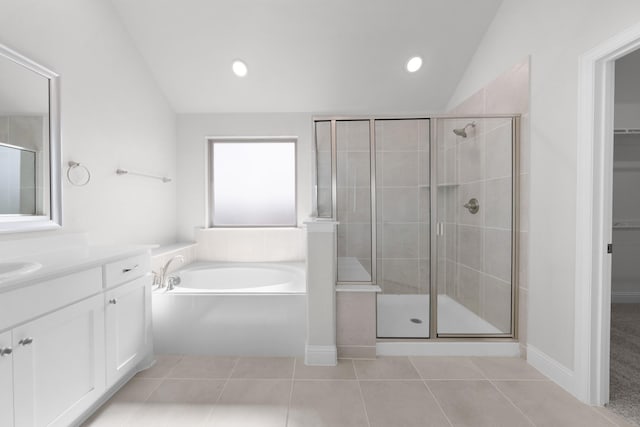 bathroom with tile patterned floors, a garden tub, a stall shower, and lofted ceiling