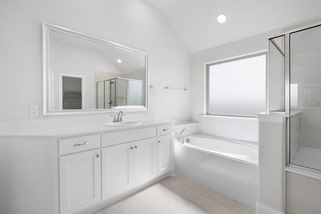 full bathroom with a garden tub, a shower stall, tile patterned flooring, lofted ceiling, and vanity