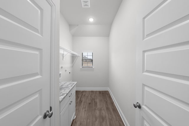 spacious closet featuring dark wood finished floors and visible vents