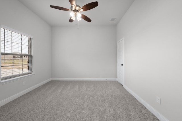 spare room featuring a ceiling fan, baseboards, visible vents, and carpet floors