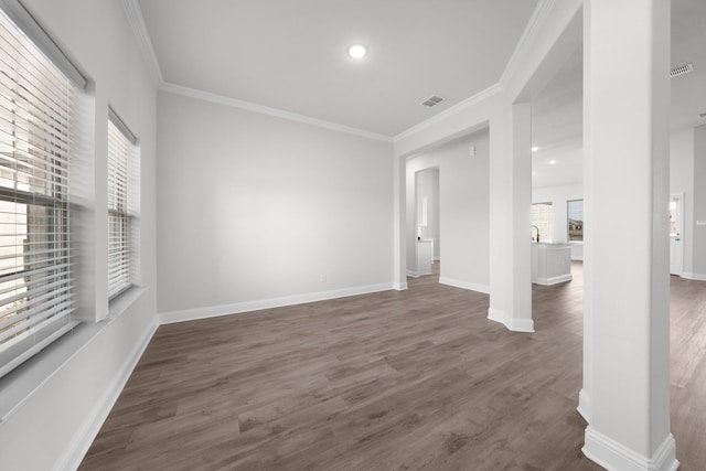 unfurnished room with dark wood-style floors, visible vents, and baseboards