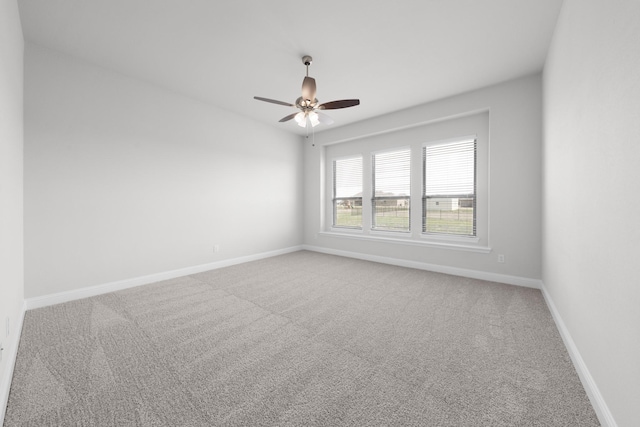 unfurnished room featuring baseboards, carpet floors, and ceiling fan