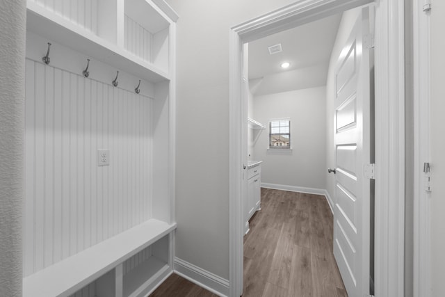 mudroom featuring dark wood finished floors, visible vents, and baseboards