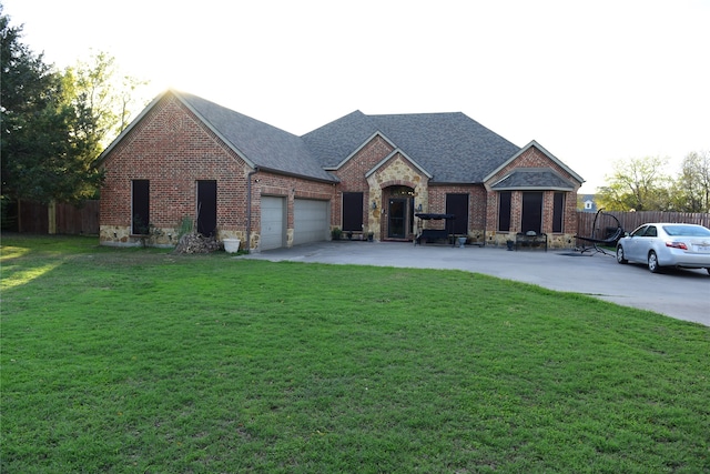 view of front of property with a front yard and a garage