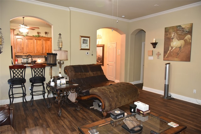 living room featuring crown molding, dark wood-type flooring, sink, and ceiling fan