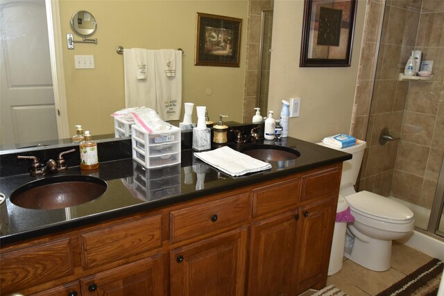 bathroom featuring tile patterned floors, vanity, an enclosed shower, and toilet