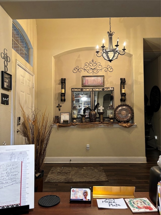 bar featuring hardwood / wood-style flooring and a notable chandelier