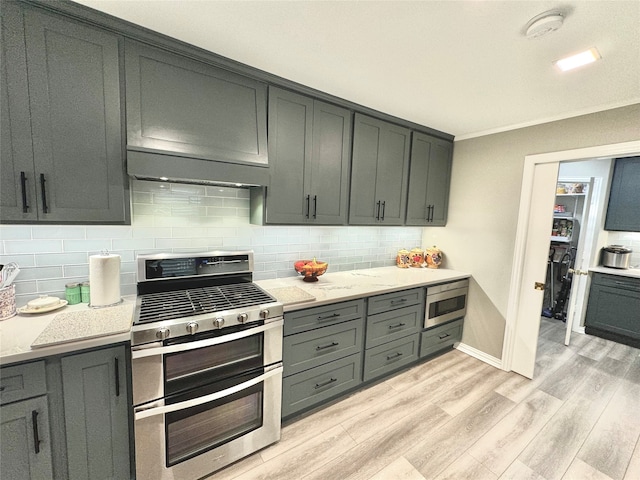 kitchen featuring decorative backsplash, stainless steel appliances, ornamental molding, light stone countertops, and light hardwood / wood-style floors