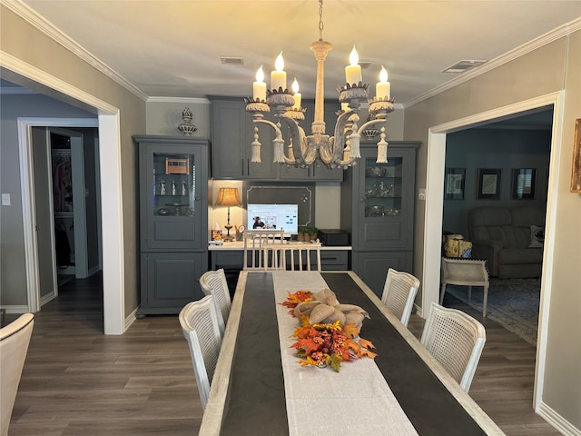 dining area featuring ornamental molding, a chandelier, and dark hardwood / wood-style floors