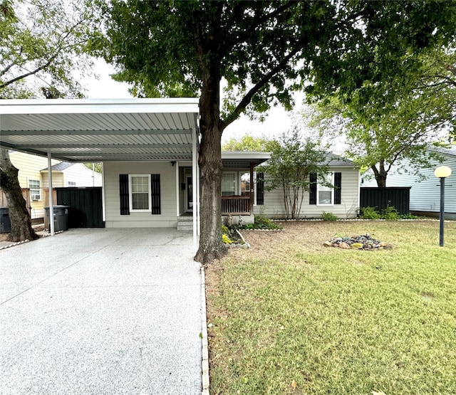 view of front of home with a front yard and a carport