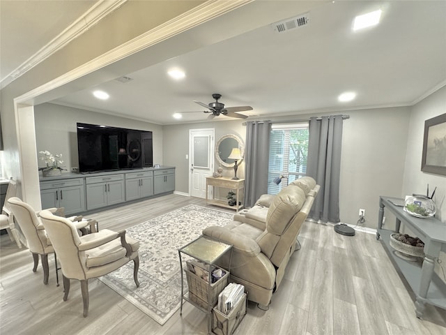 living room with crown molding, light wood-type flooring, and ceiling fan