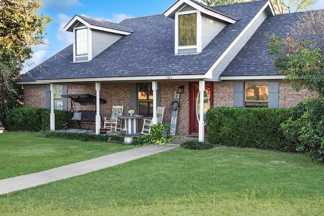 101 Scenic Dr, Dublin, TX 76446 - cape cod house featuring brick siding, a porch, a front lawn, and a shingled roof