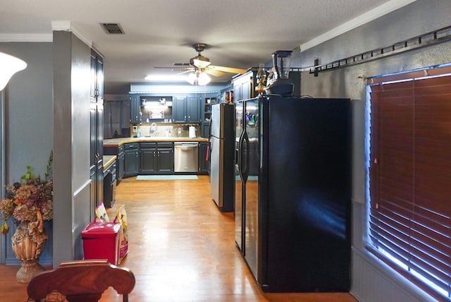 101 Scenic Dr, Dublin, TX 76446 - kitchen with appliances with stainless steel finishes, light wood finished floors, a ceiling fan, ornamental molding, and tasteful backsplash