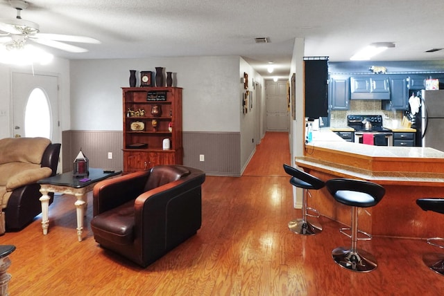 101 Scenic Dr, Dublin, TX 76446 - living area featuring wainscoting, a ceiling fan, and light wood finished floors
