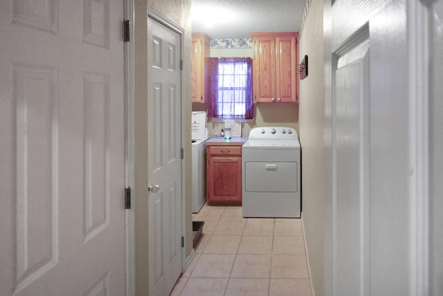 101 Scenic Dr, Dublin, TX 76446 - clothes washing area with washer / clothes dryer, cabinet space, and light tile patterned flooring