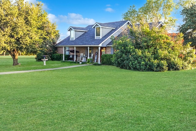 101 Scenic Dr, Dublin, TX 76446 - cape cod house with a front lawn, covered porch, brick siding, and a shingled roof