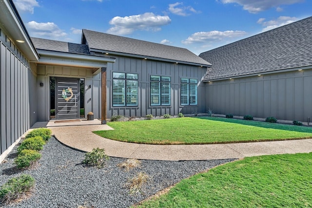 property entrance with a lawn