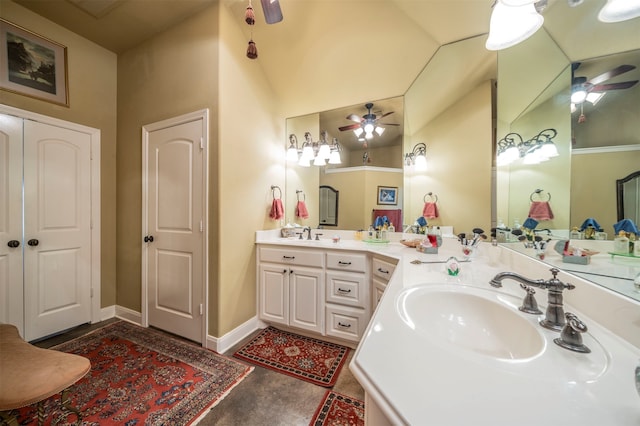 bathroom with vanity, ceiling fan, and vaulted ceiling