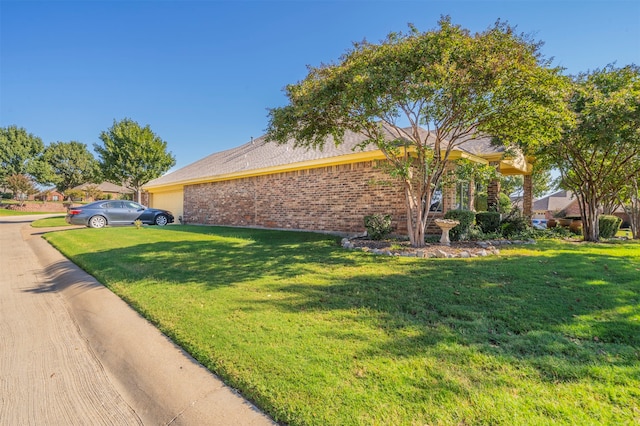 view of side of home with a lawn