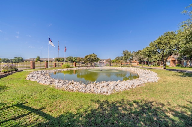 view of community with a water view and a yard