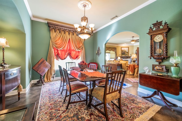 dining area with ornamental molding and ceiling fan with notable chandelier