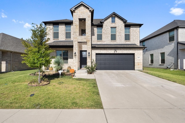 view of front of property featuring driveway, roof with shingles, a front lawn, stone siding, and a garage