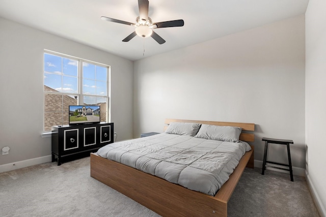 bedroom with multiple windows, ceiling fan, and carpet