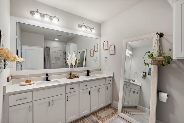 bathroom with vanity and curtained shower