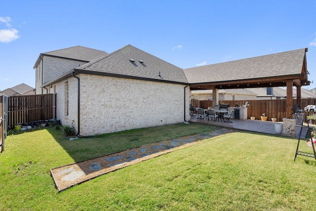 rear view of property with a patio and a yard