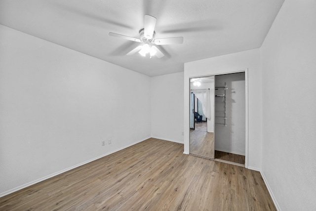 unfurnished bedroom with ceiling fan, light hardwood / wood-style floors, and a closet