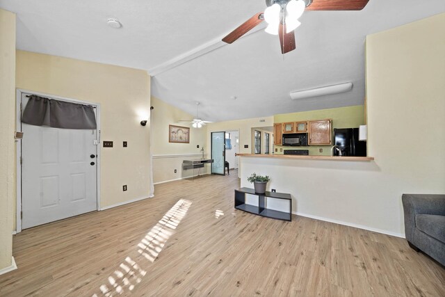 entryway with lofted ceiling with beams and light wood-type flooring